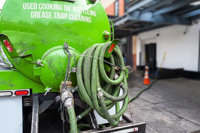 a grease trap pumping truck at a restaurant in Delran